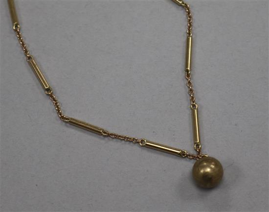 A 9ct gold baton and chain link necklace with spherical drop, 46cm.
